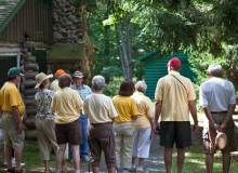 A group touring the James Tellen Woodland Sculpture Garden.